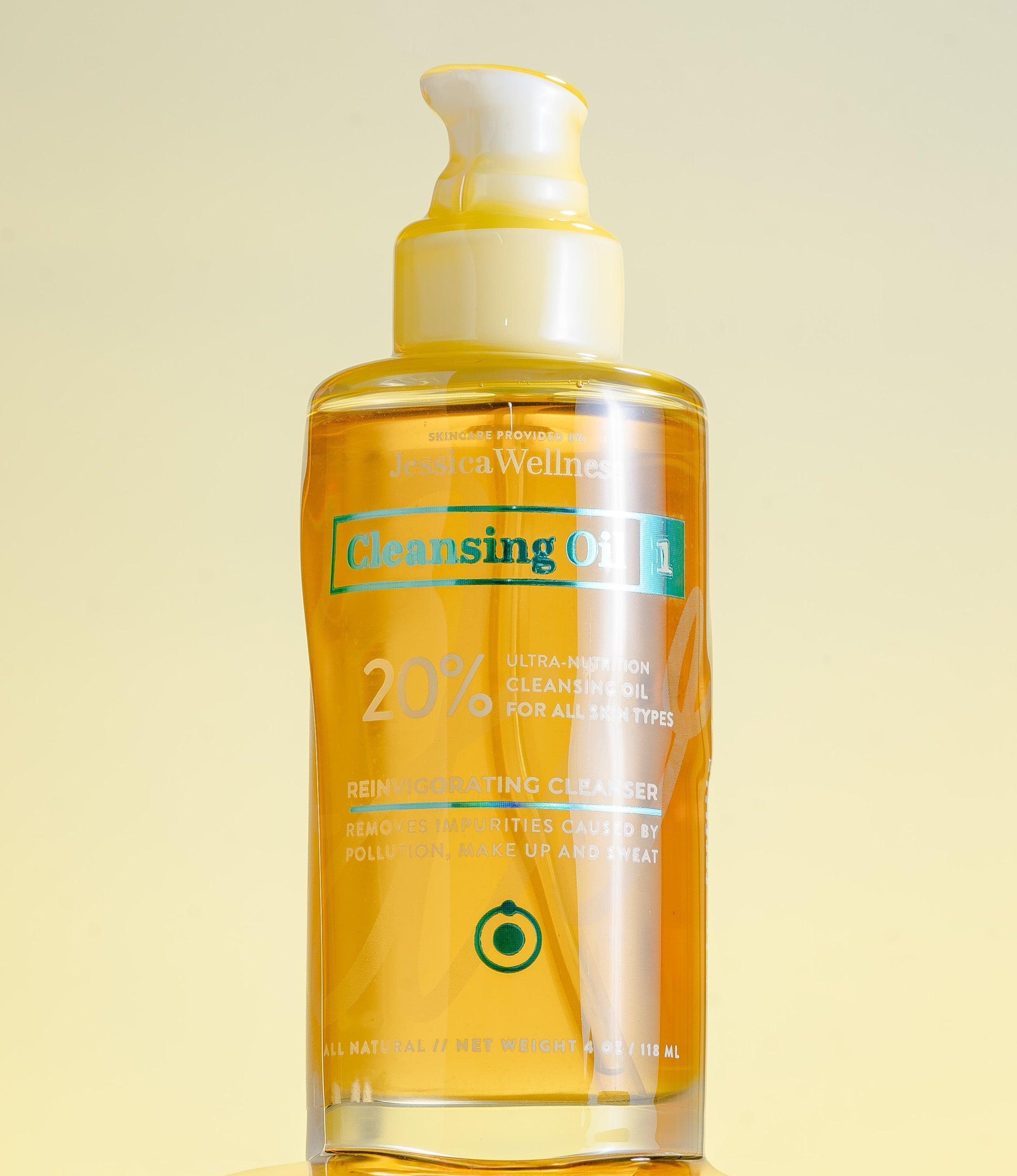 Bottle of cleansing oil with a pump on a light yellow background