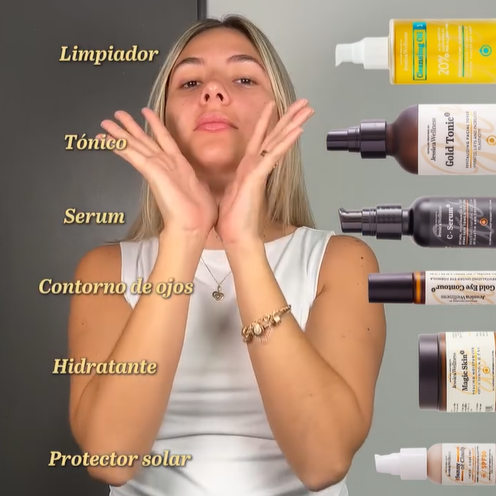 Woman demonstrating skincare routine with products on a gray background